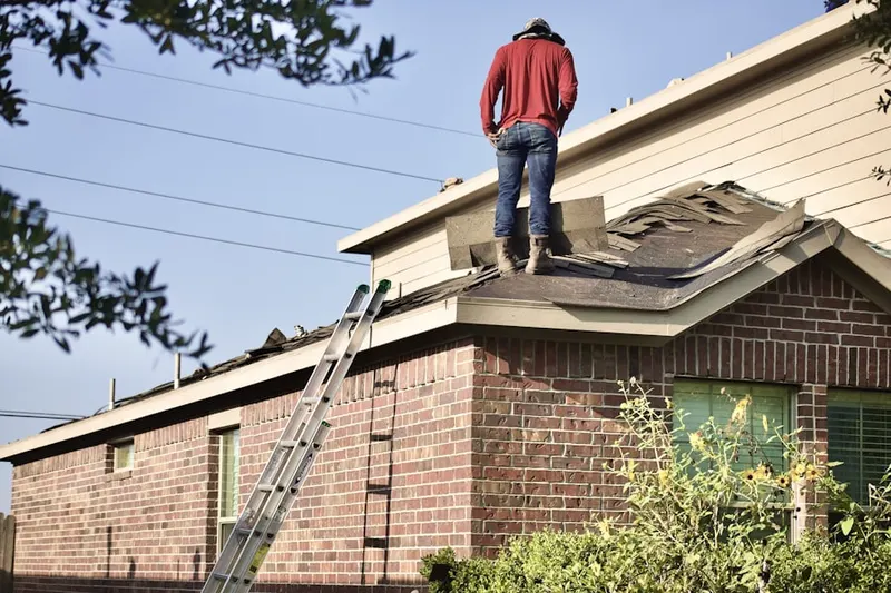 Professional roofer working on a residential roof in Willoughby Court